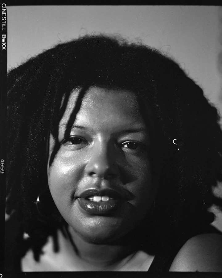 Black-and-white portrait of a woman with textured hair