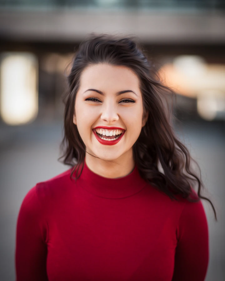 Smiling woman in a red top, sample portrait